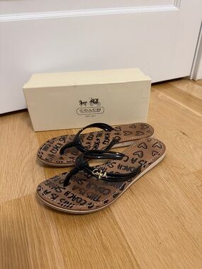 Coach Brown Logo Print Flip Flop Sandals with Black Glossy Straps and Gold Charm